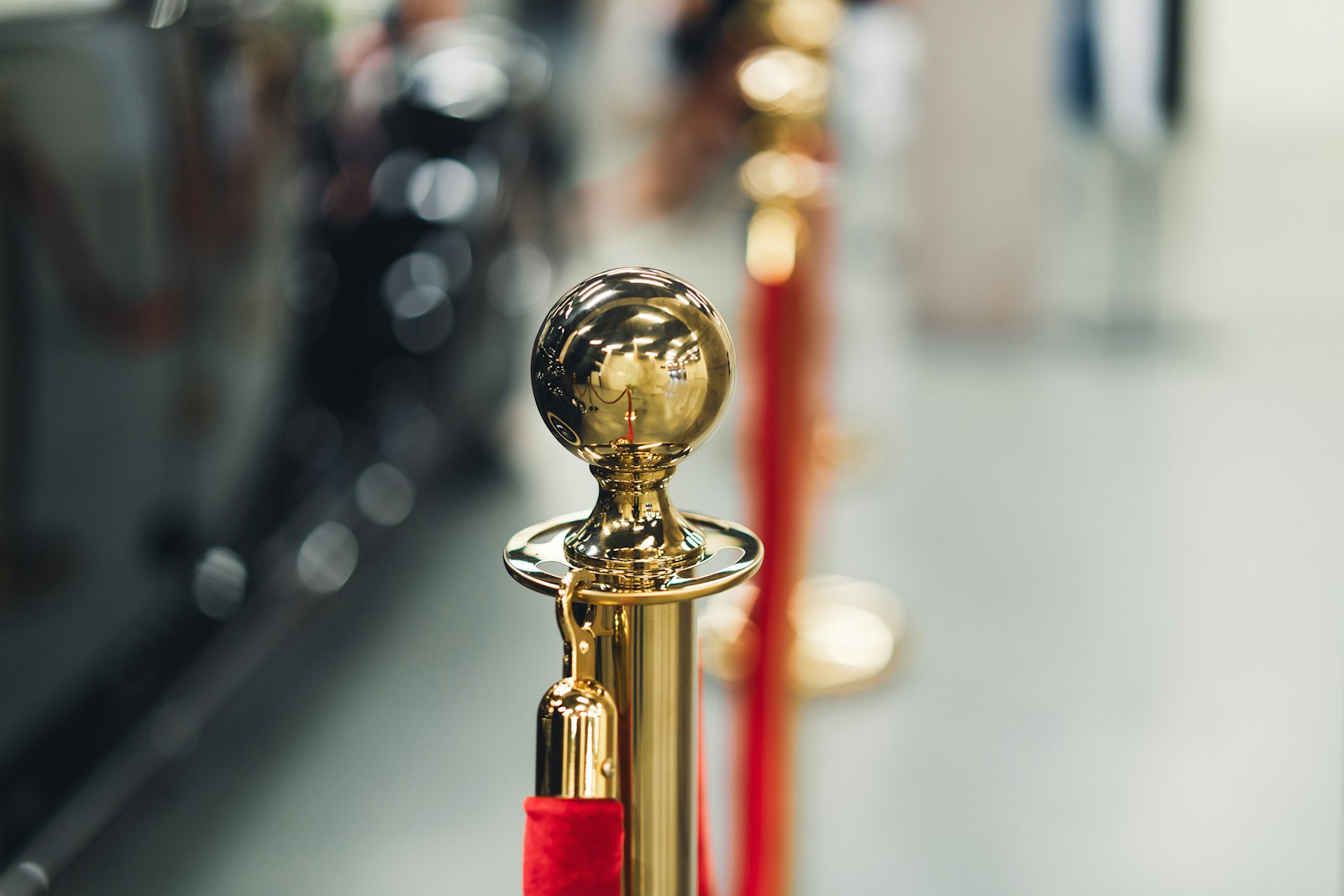 a row of red and gold poles with a golden ball on top